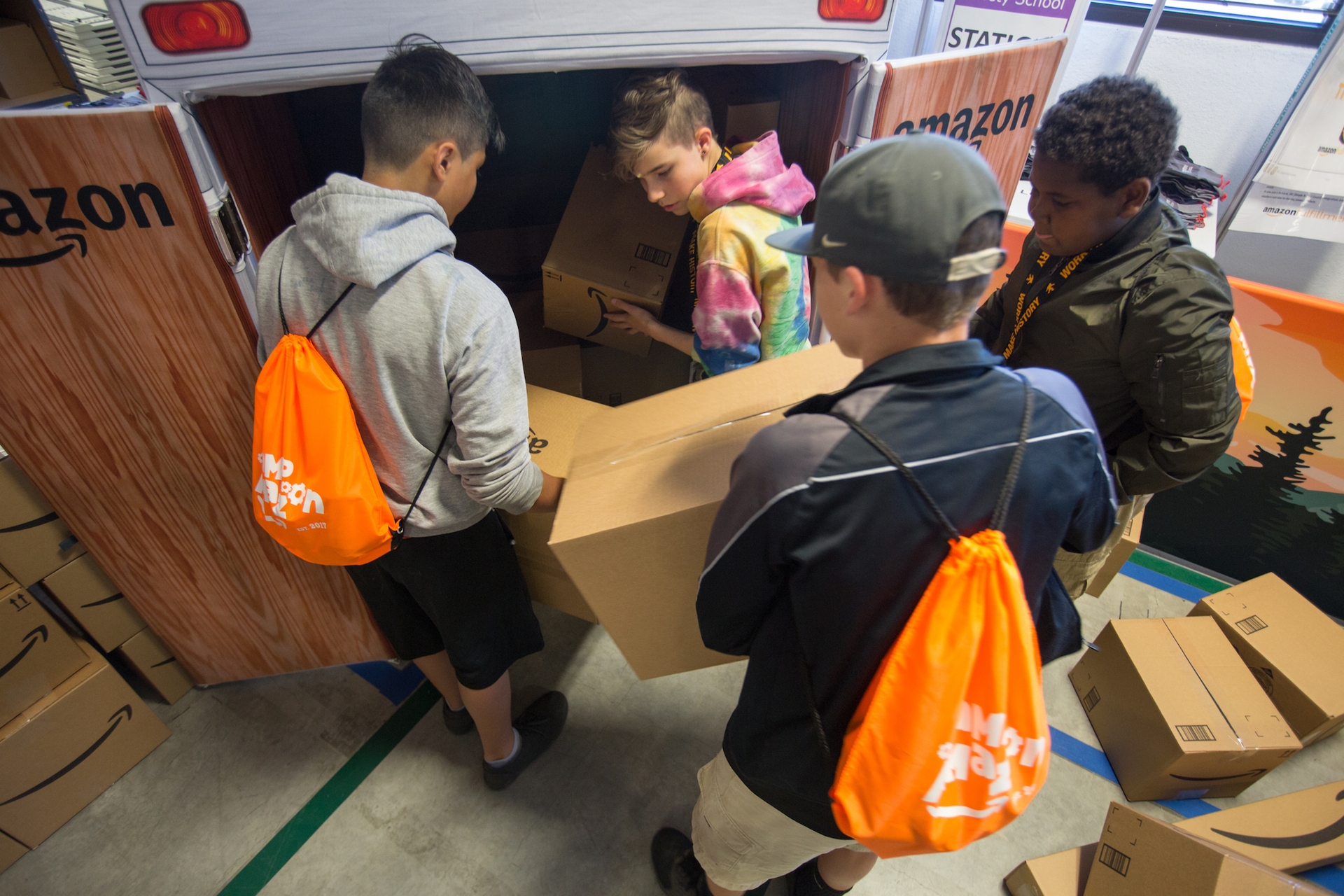 Students participate in a Camp Amazon event at a fulfillment center in Washington