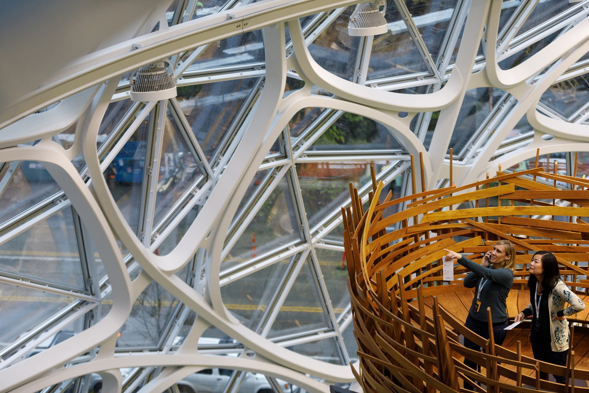 Two women stand in The Nest within the Amazon Spheres on opening day.