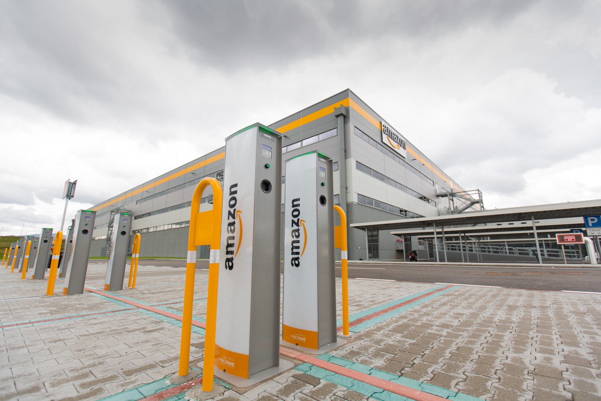 An electric car charging station outside of an Amazon fulfillment center in Italy.