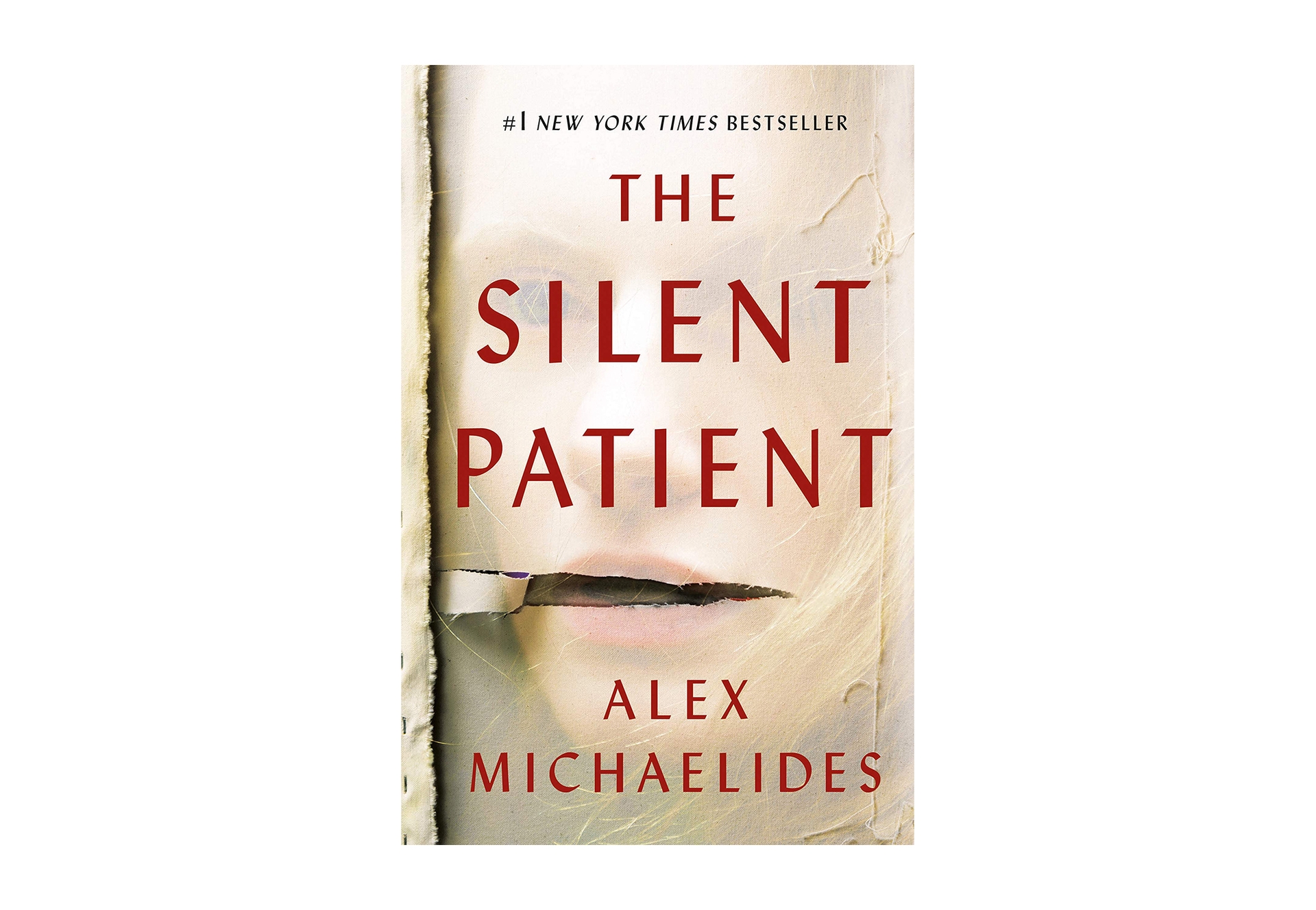 Book cover for "The Silent Patient" by Alex Michaelides, a woman's face appears to show from under a gauzy material, with a tear near the mouth. The Title and authors' name are in sans-serif red font in all caps.