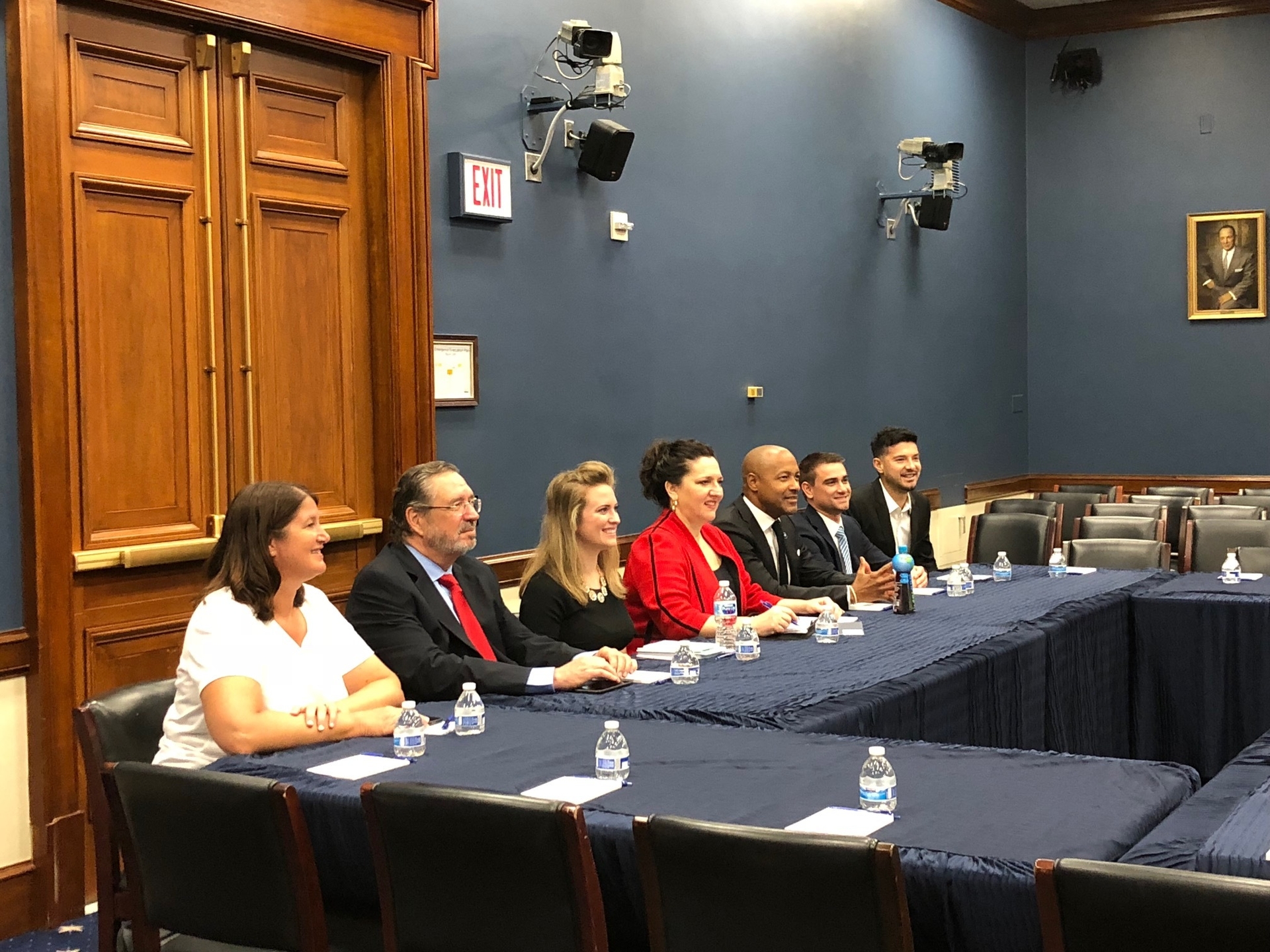 Small business owners, seated at a table, as they meet with political leaders in Washington D.C.