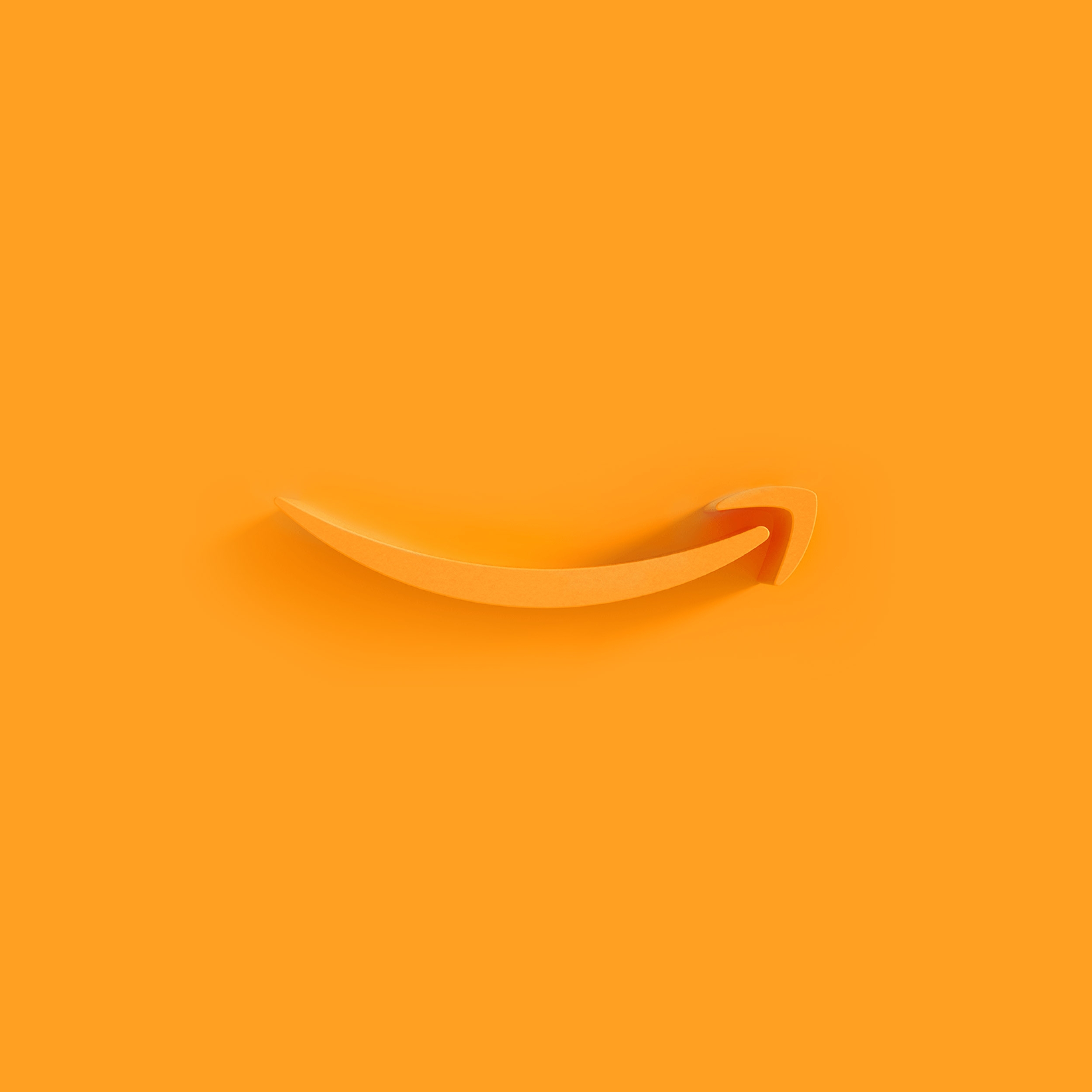 Amazon's orange smile logo appears as an extruded plastic form on an orange background, with a shadow cast by a light source from the right