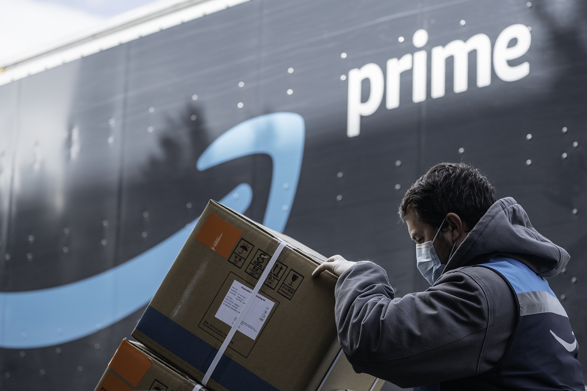 An Amazon driver delivers boxes of medical supplies. 